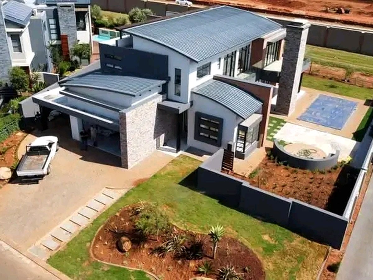 Modern luxury house aerial view with swimming pool and landscaped garden